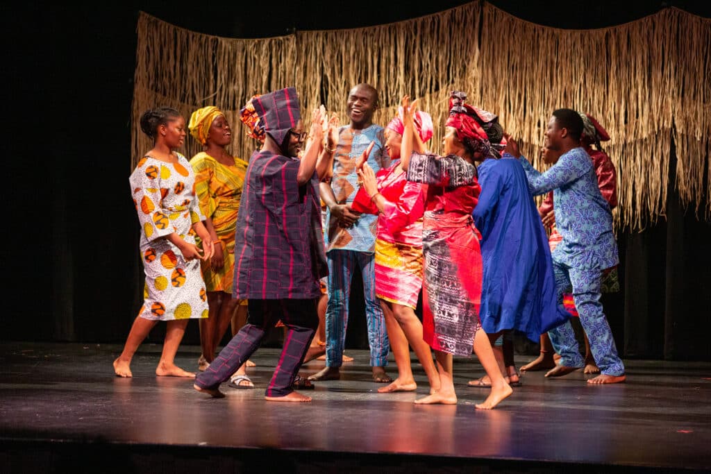The company of A Journey to Africa dancing