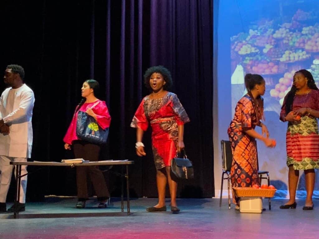Soro Soke: performers in a scene around a table