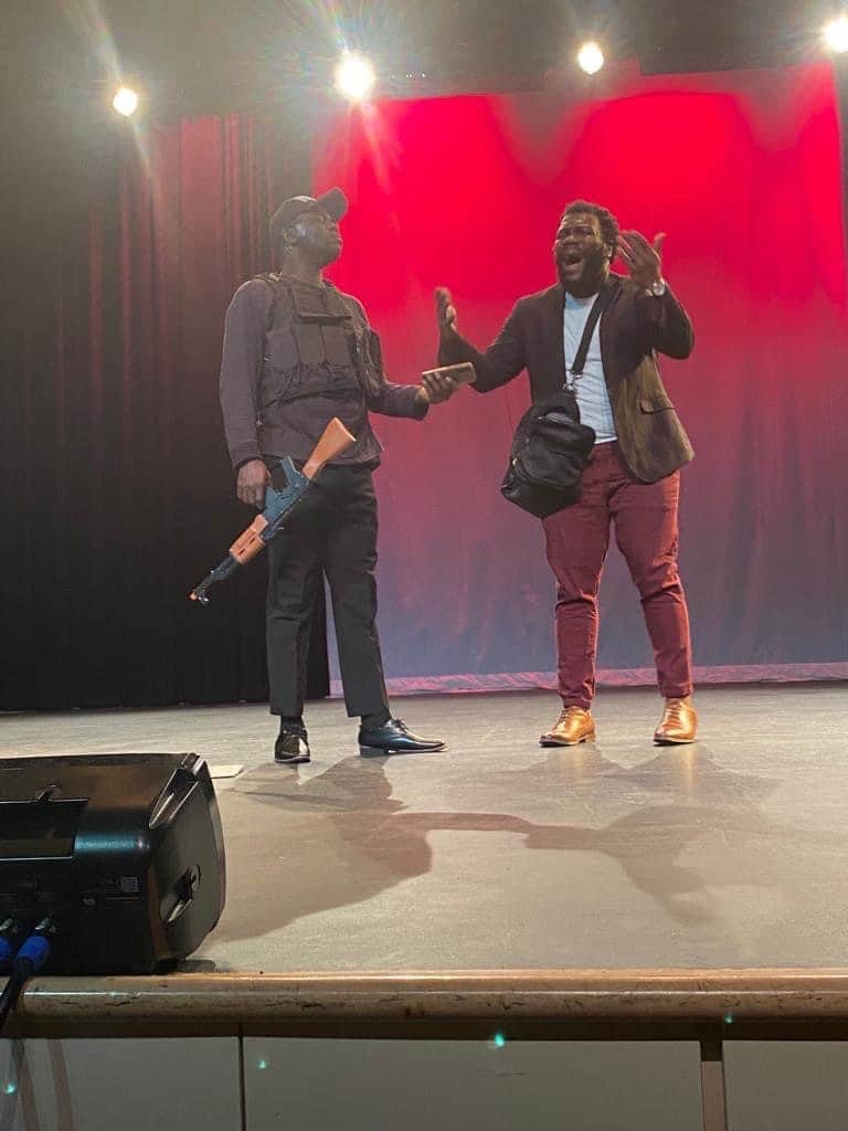 Soro Soke: an armed officer confronts a man on stage