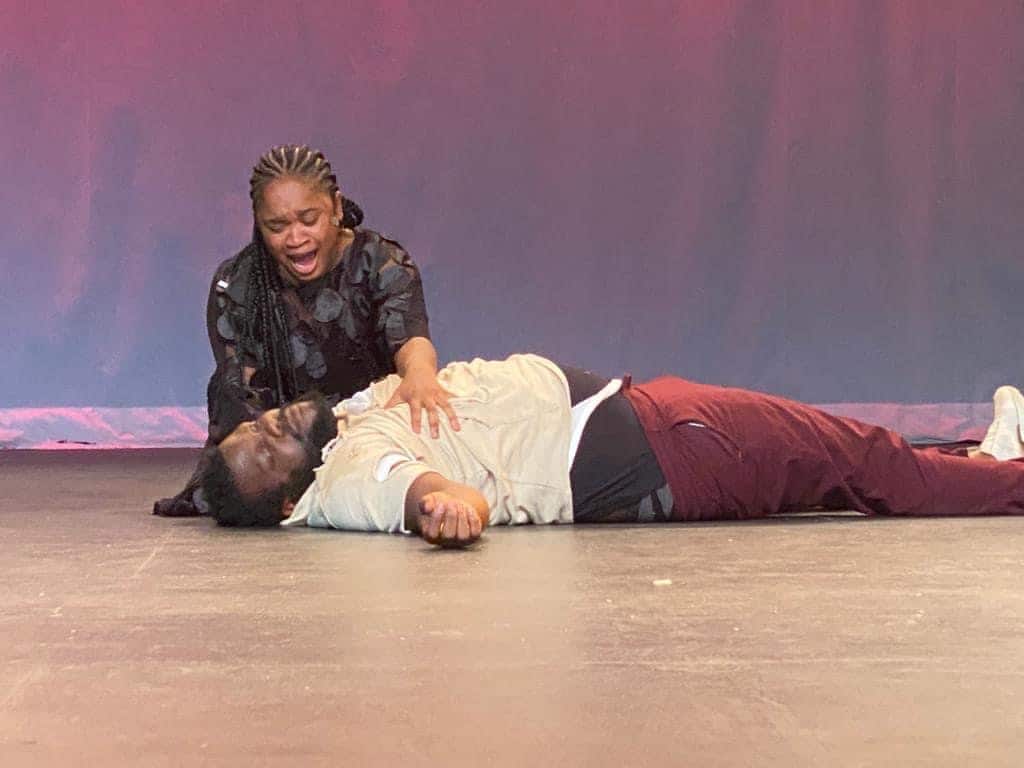 Soro Soke: a performer kneels over a fallen man